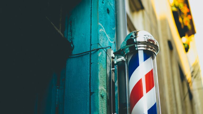 close-up photography of gray stainless steel dispenser