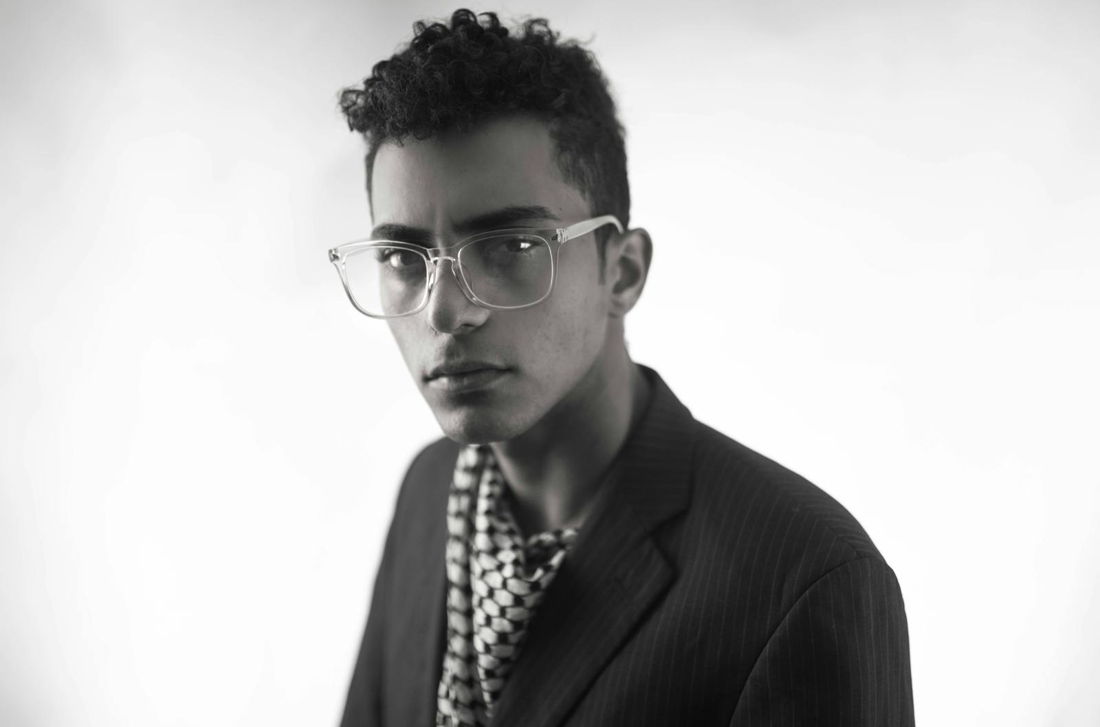 Stylish young man with eyeglasses in grayscale portrait