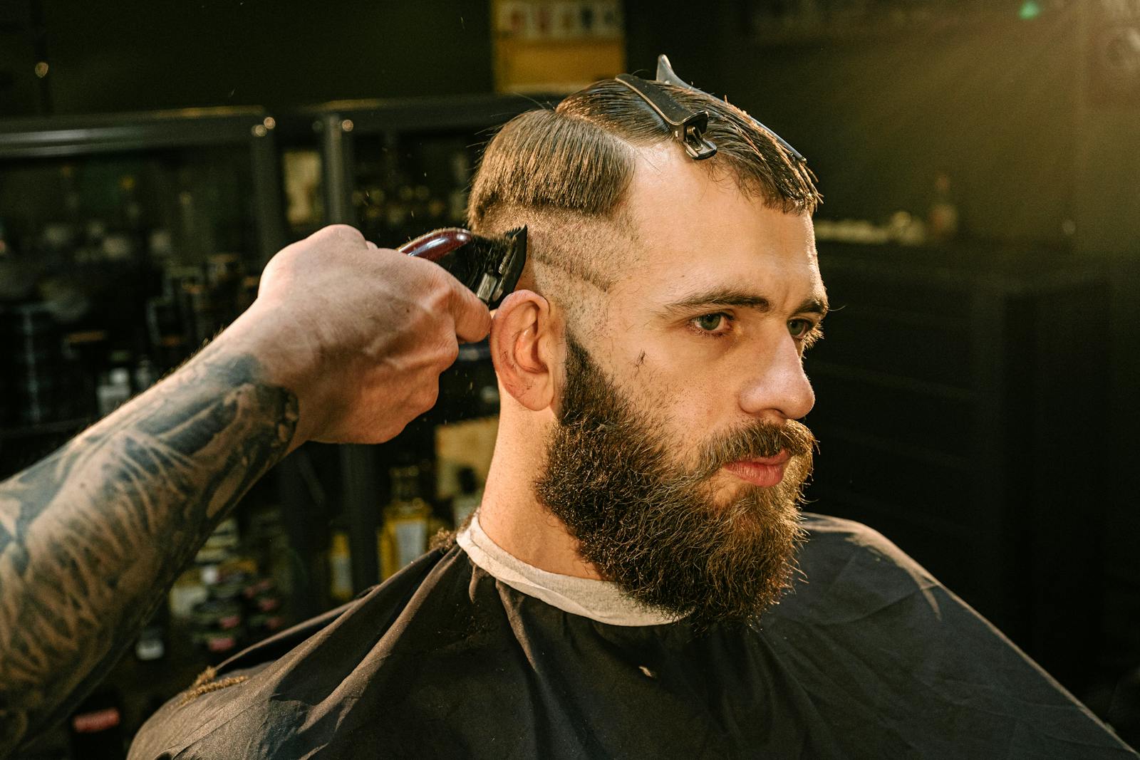 Professional haircut and beard grooming session in a barber shop captured in detail.