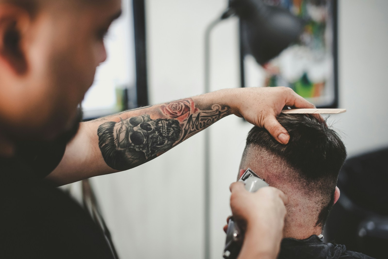 man cutting hair of man