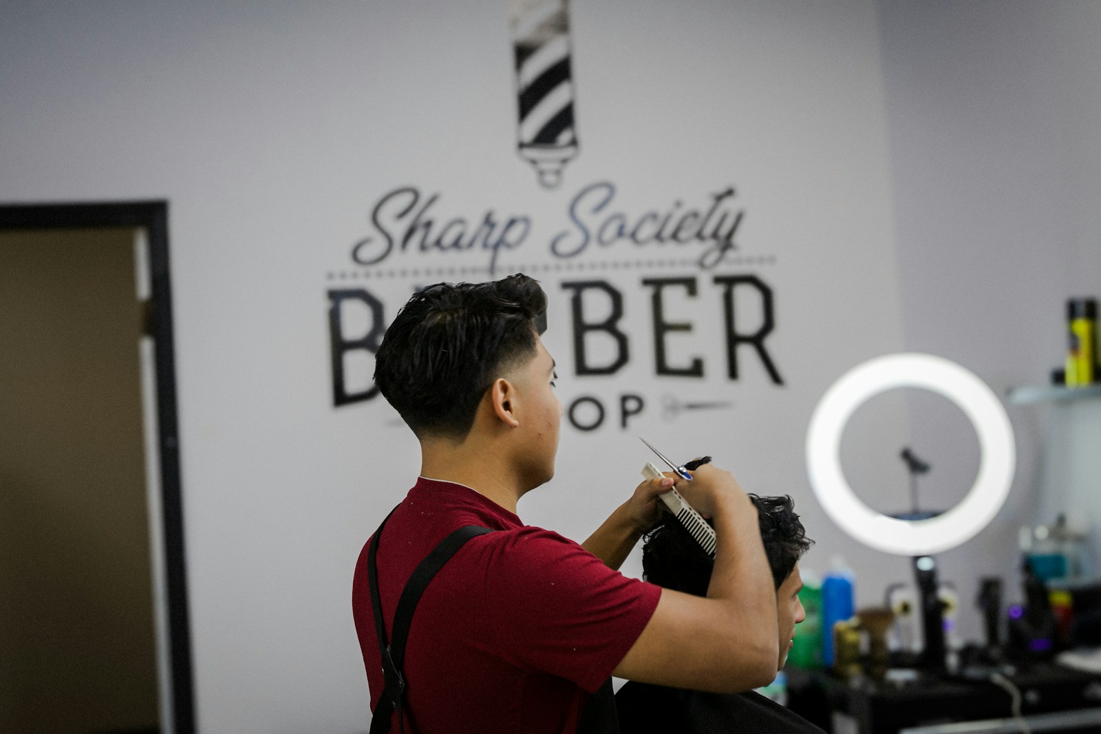 A man standing in front of a barber shop